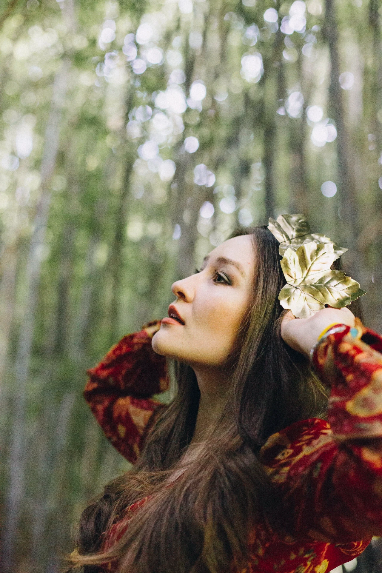 Woman with a gold leaf hairpiece in a bamboo forest