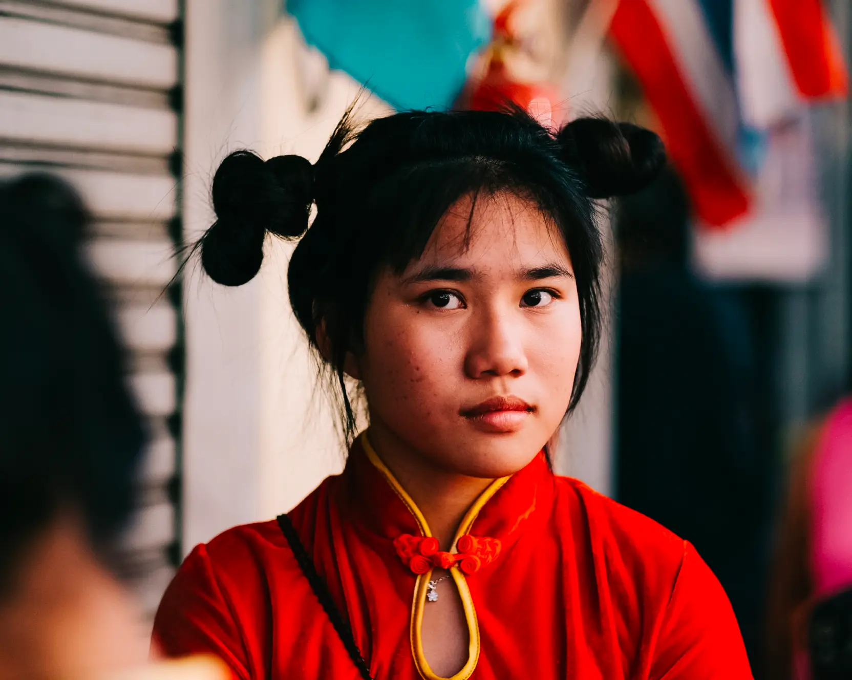 Young woman in a red cheongsam at a Chinese New Year street celebration