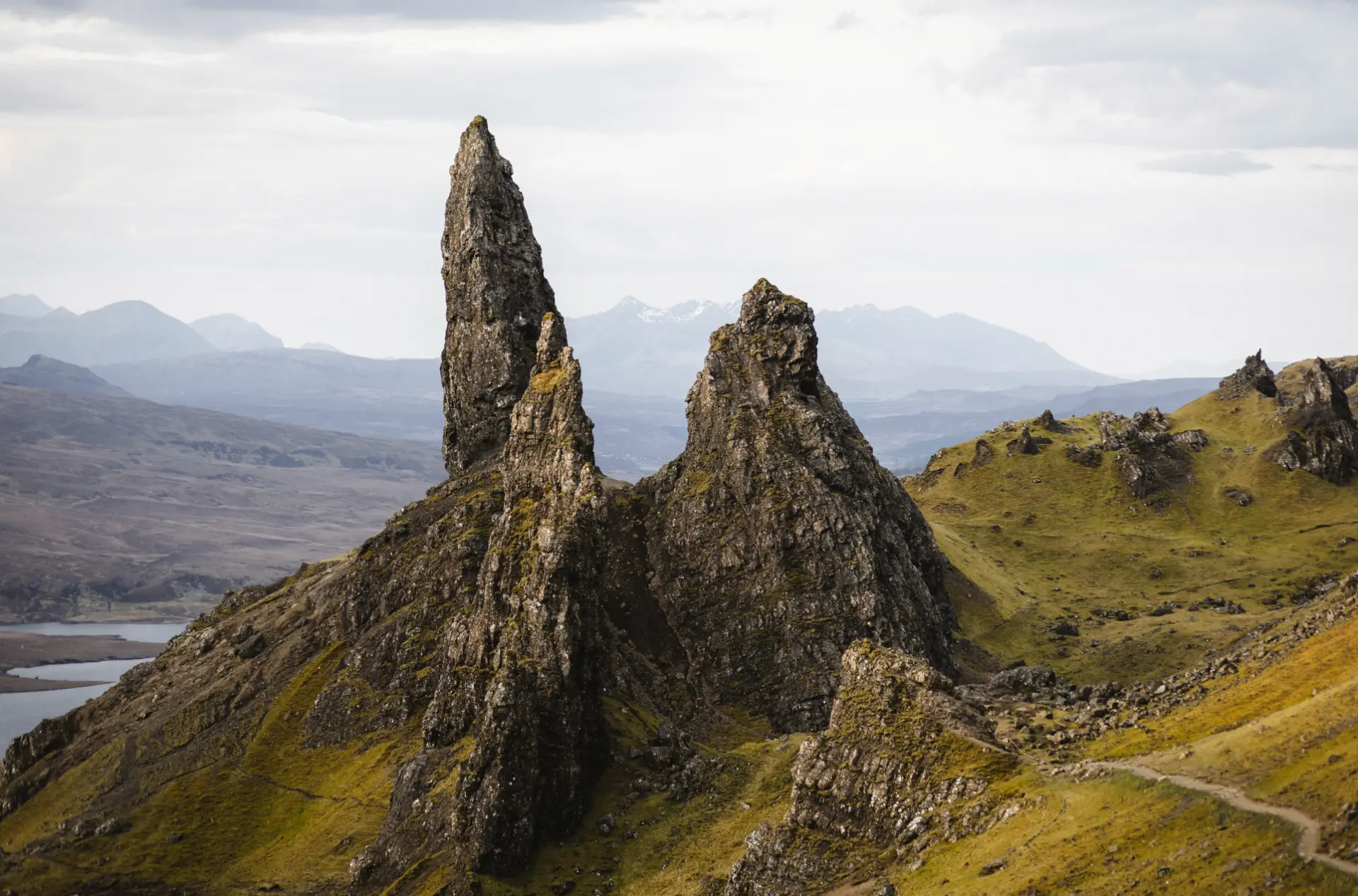 The Old Man of Storr rock pinnacles above a loch on the Isle of Skye