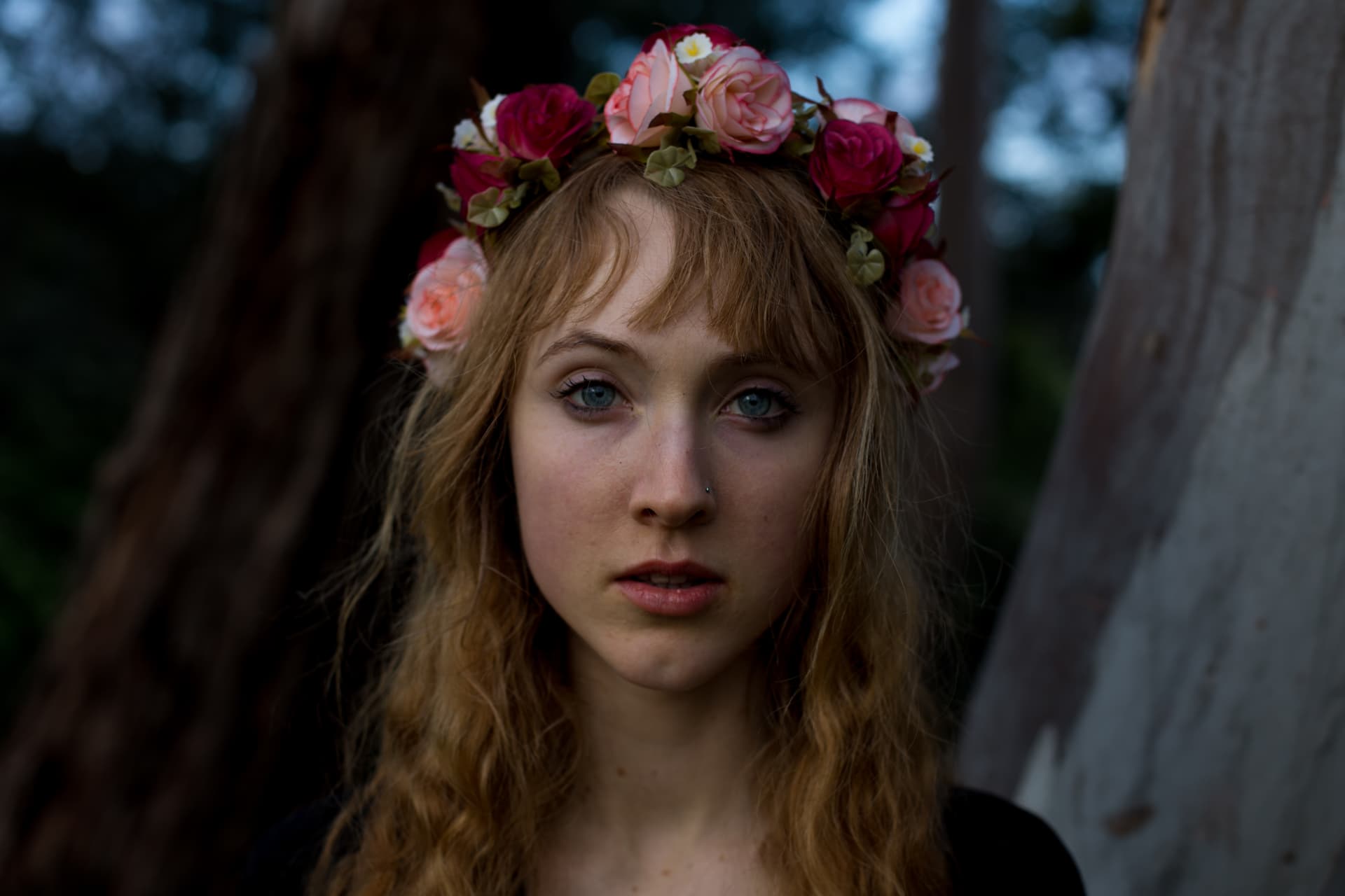 Portrait of a woman wearing a rose flower crown at dusk
